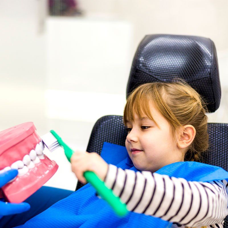 Dentist Teaching Cute Girl About Oral Hygiene — Bunbury WA — FADC Dental Group