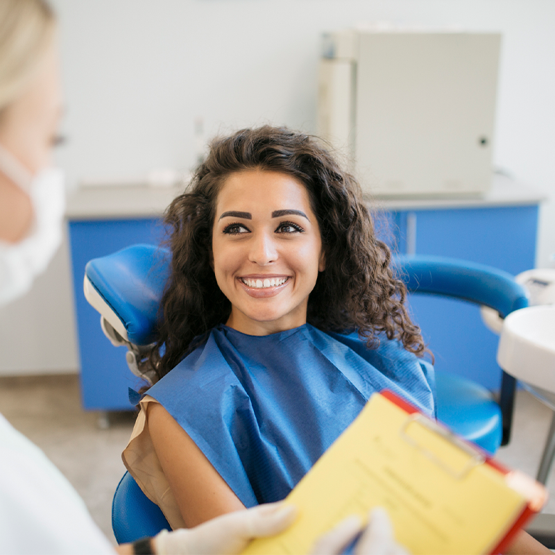Attractive Young Caucasian Woman Talking to Her Dentist — Bunbury WA — FADC Dental Group