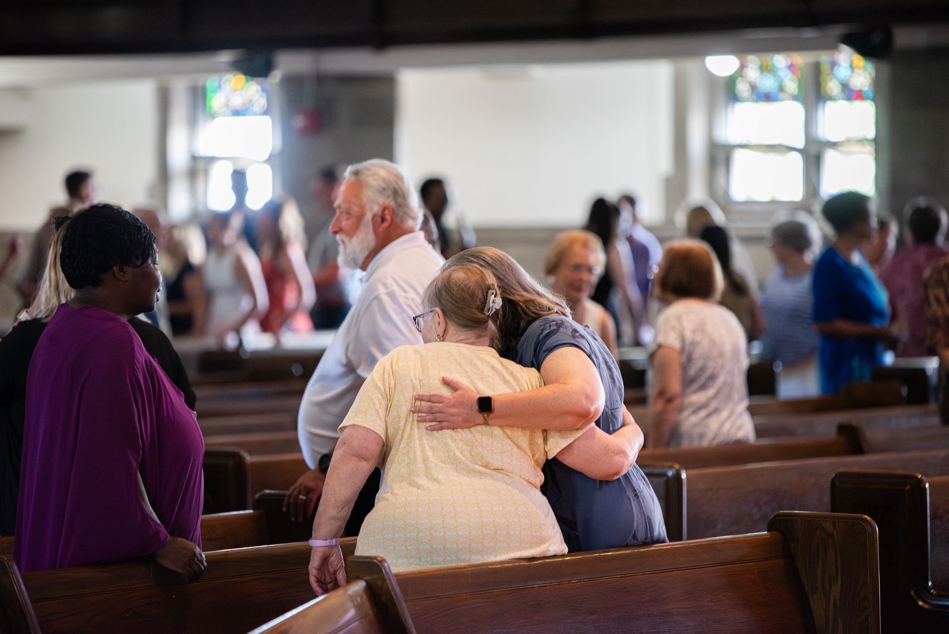 people hugging in church
