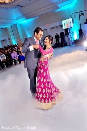 fog effects in ballroom for wedding with couple dancing and laughing