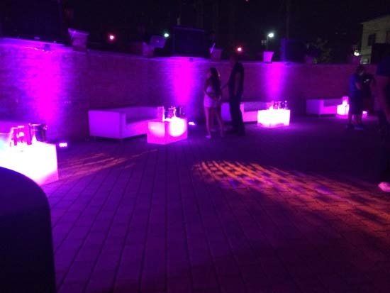 white lounge furniture and decor with pink lights