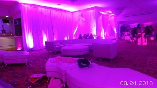 white lounge furniture and decor with pink lights