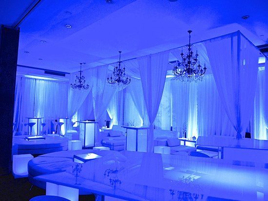 lounge tables with stools in blue lit room