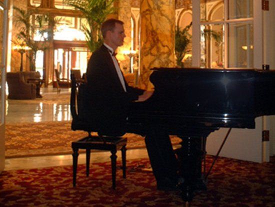 man playing music at piano