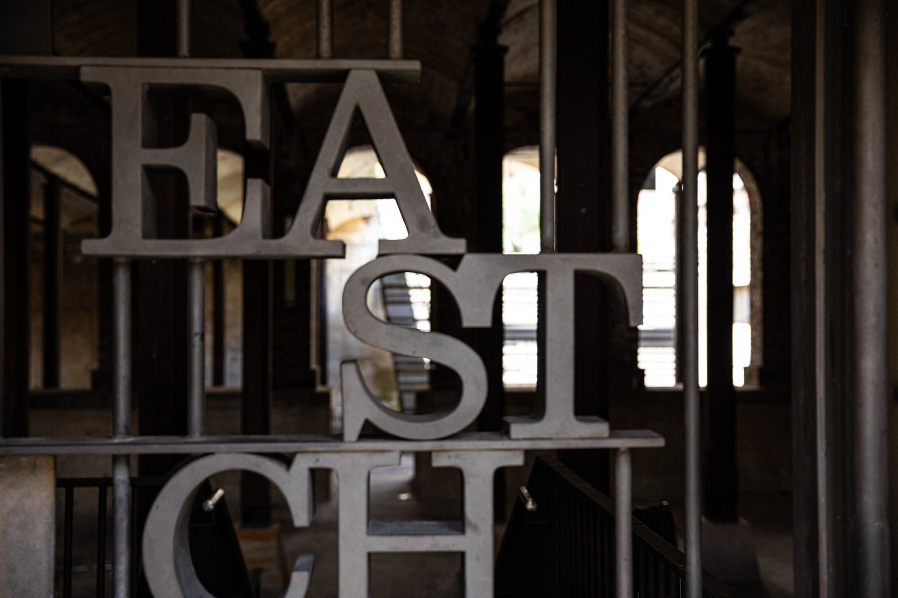 Lettering In Metal Fence — Professional Writing Consultant in Australia