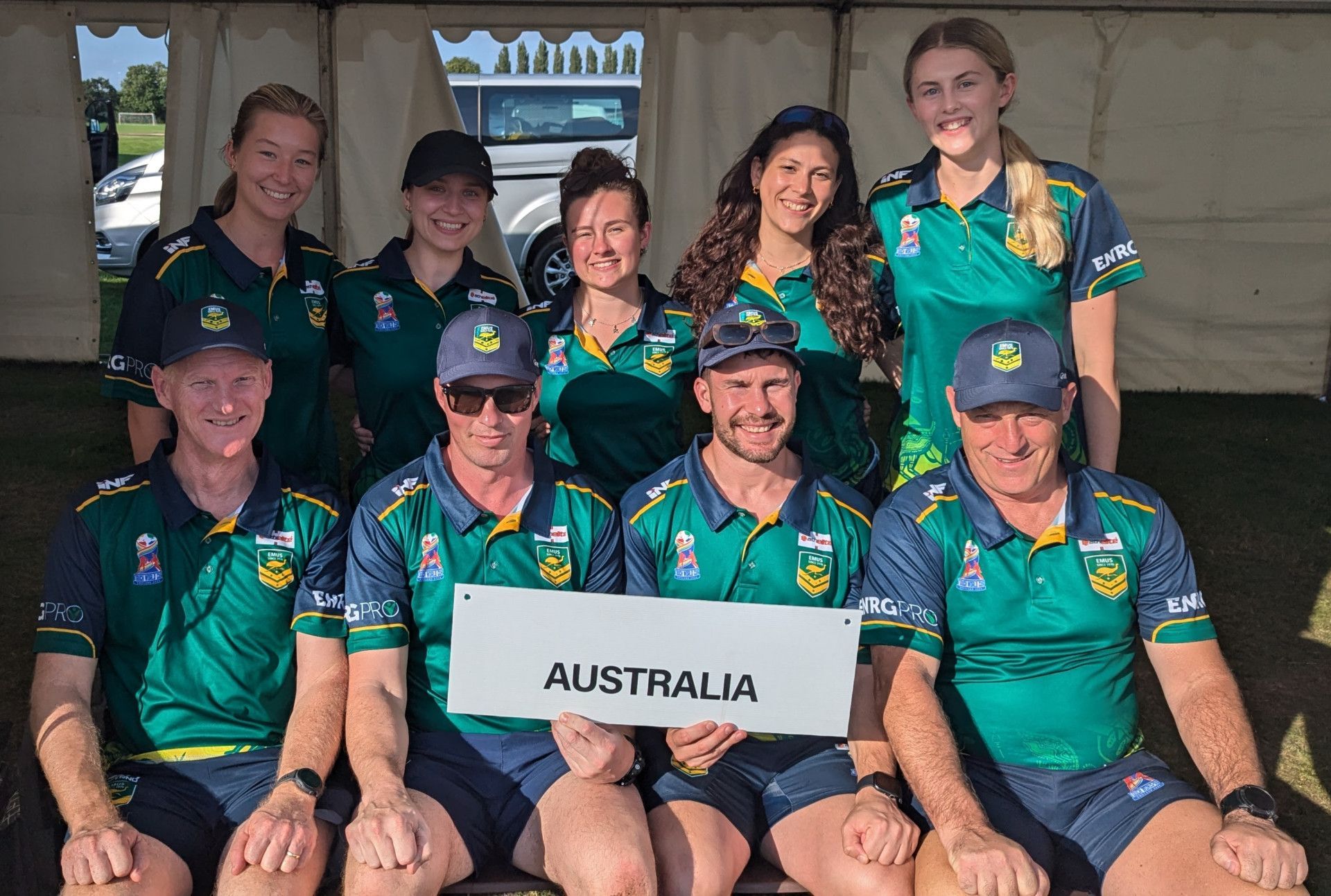 A Group of People Are Sitting in Front of a Body in Motion Physiotherapy Sign — Body In Motion Physiotherapy In Pialba, QLD