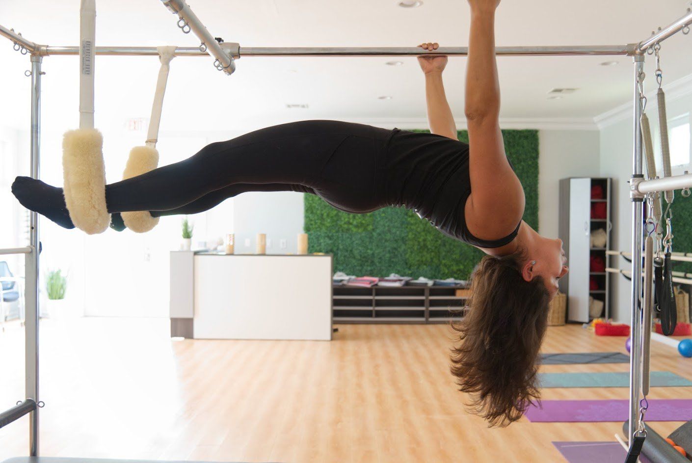 Trainor Hanging on Bars — Morganville, NJ — Vida Holistic Wellness Studio