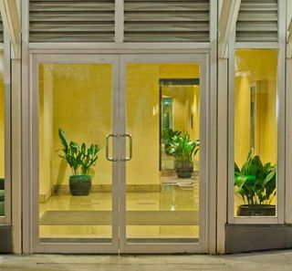 An glass entrance door to a lavish office