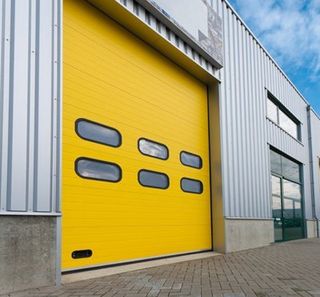 A yellow industrial garage door from GT Automation