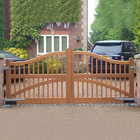 A closed automatic wrought iron gate to a domestic driveway