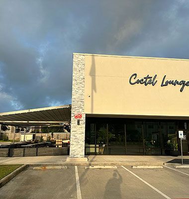 A large building with a lot of windows and a parking lot in front of it.