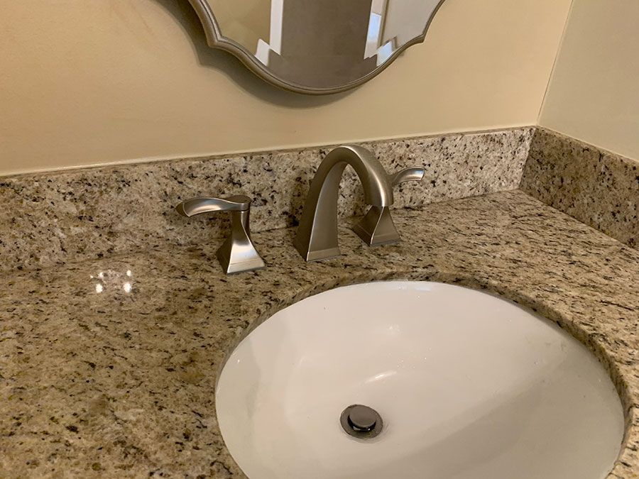 A bathroom sink with a mirror above it and a faucet.