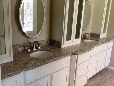 A bathroom with two sinks and a mirror.