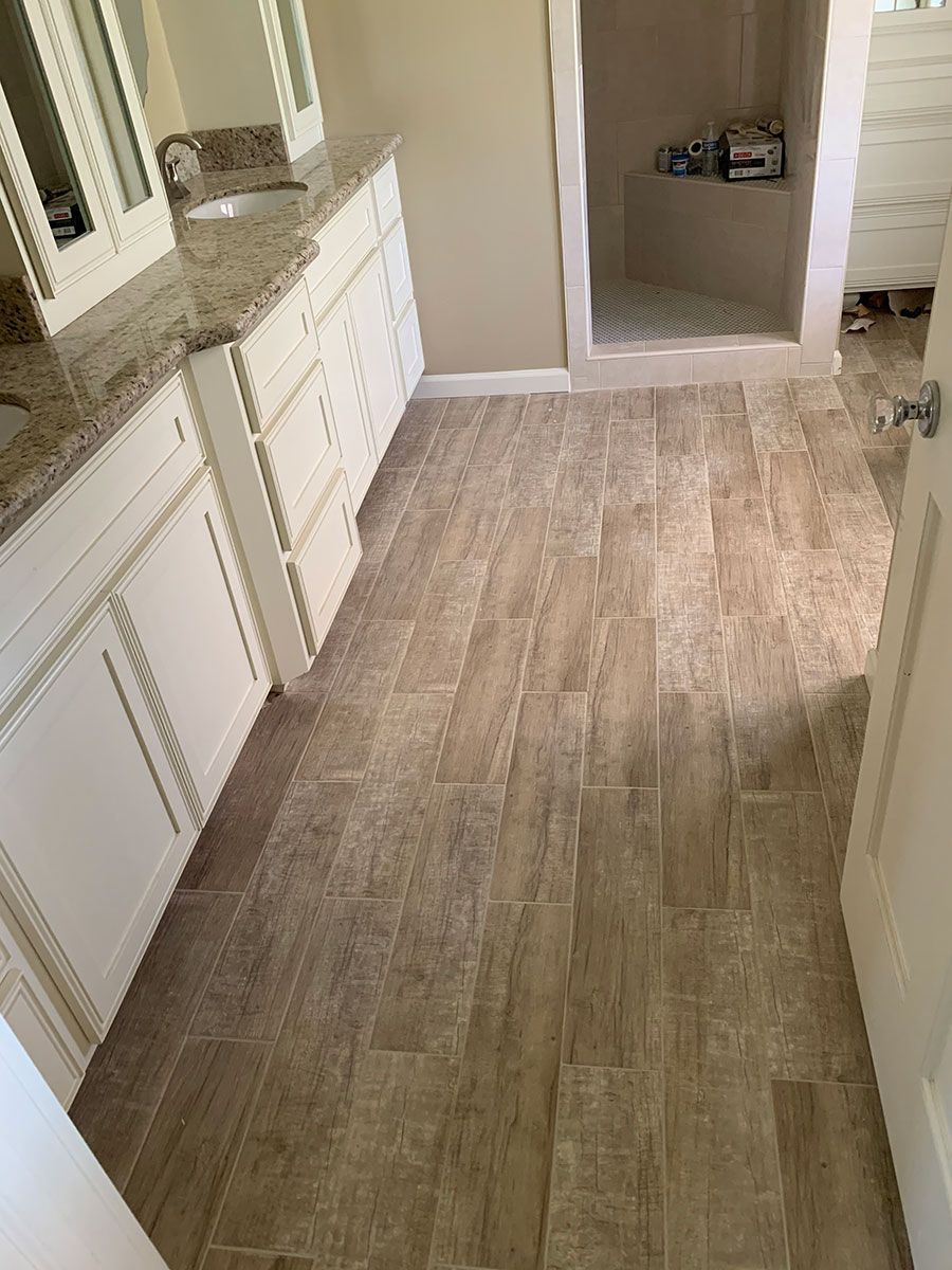 A bathroom with two sinks and a walk in shower.