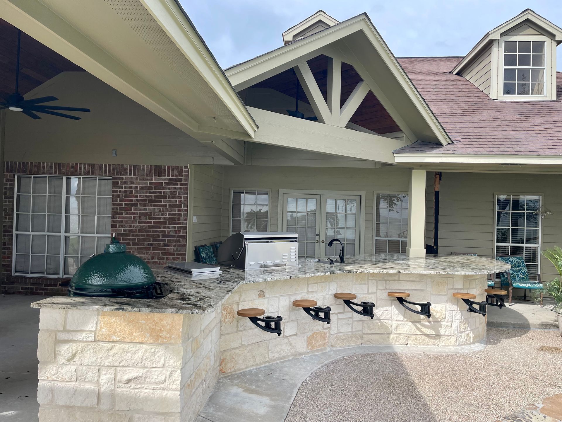 A large house with a large green egg in the backyard.