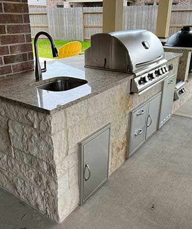 There is a grill and a sink in the kitchen.
