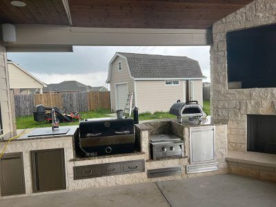 There is a grill and a fireplace in the backyard.