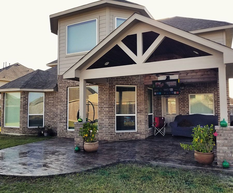 A large brick house with a porch and a patio