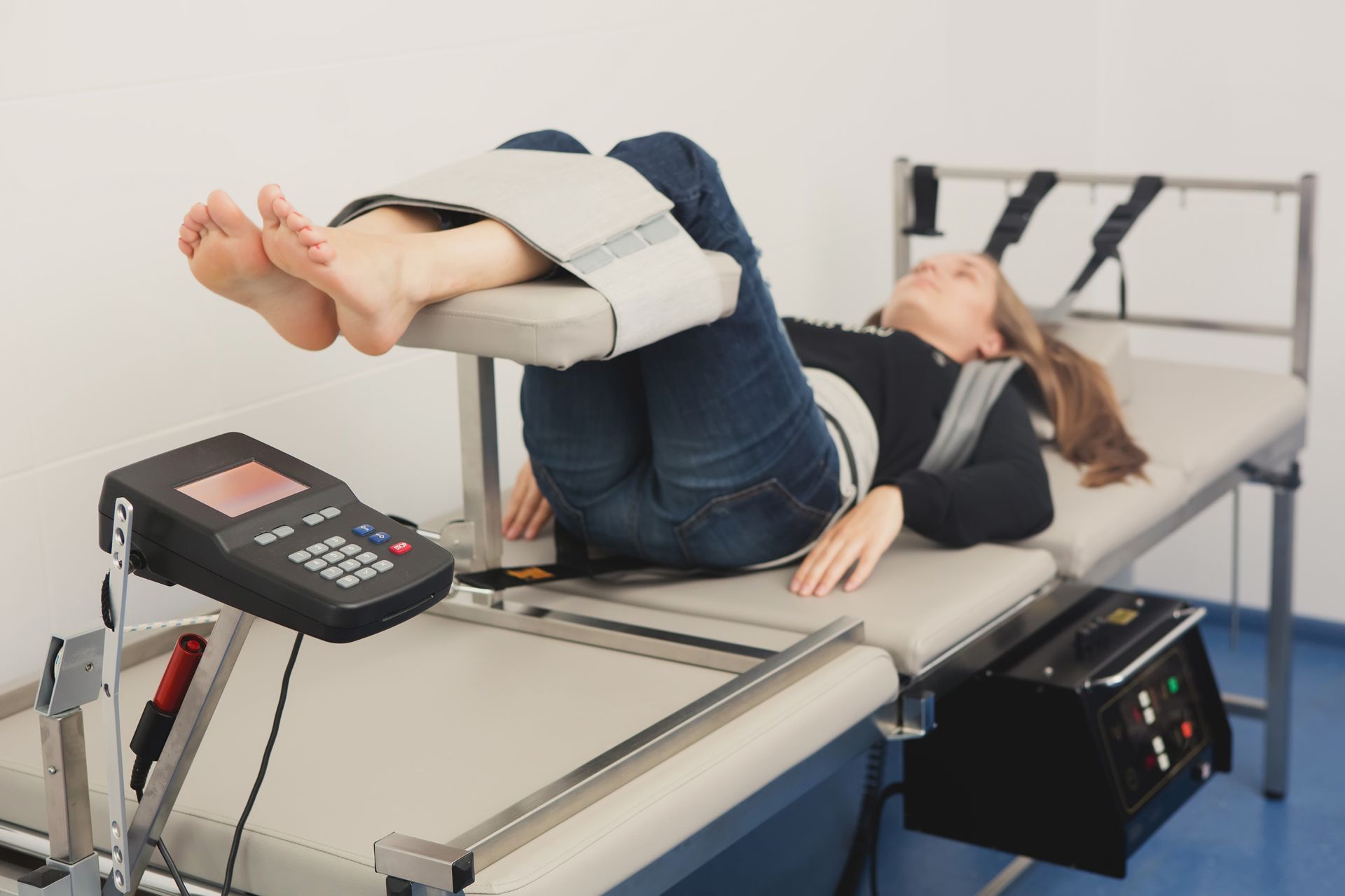 A woman is laying on a table with her feet up.