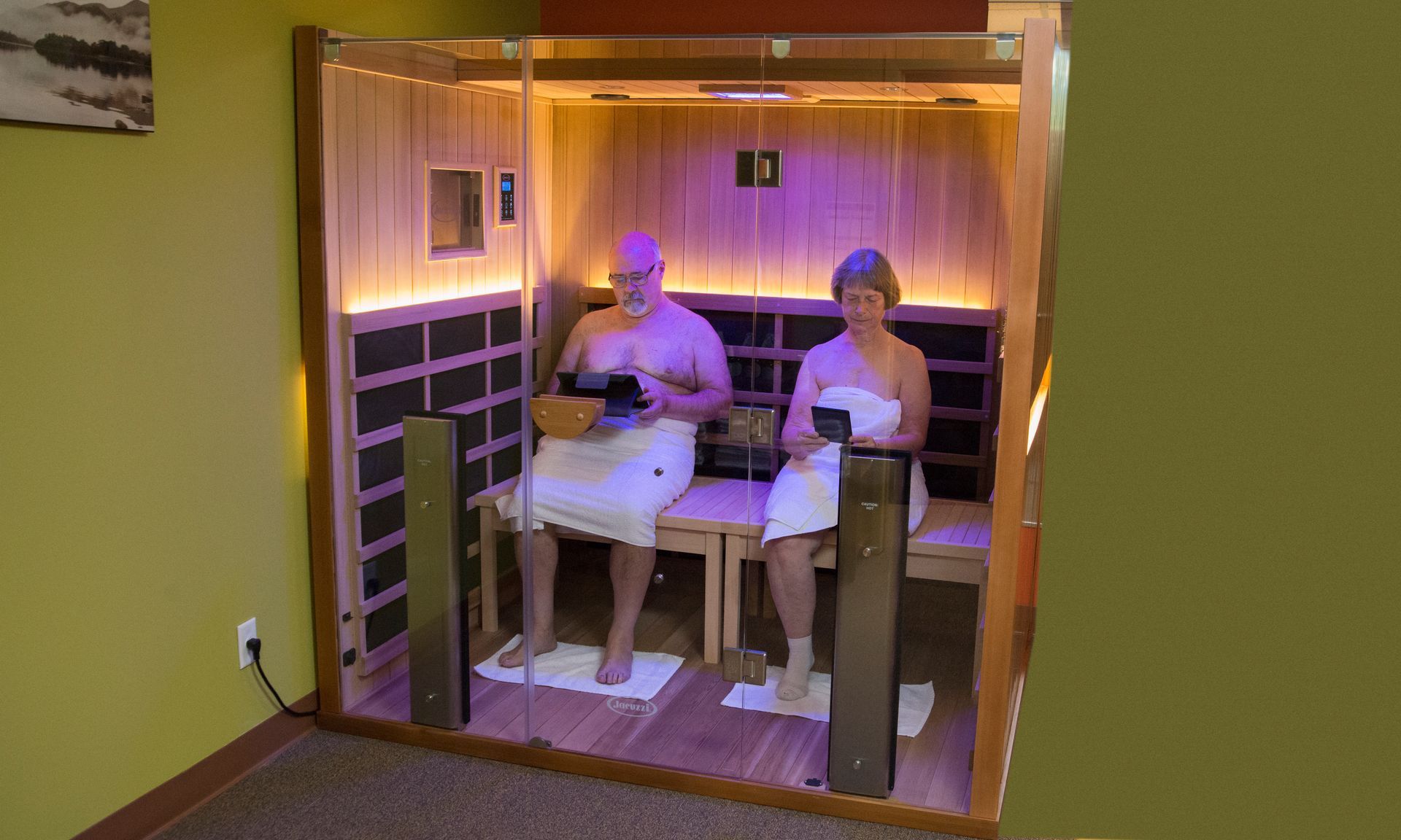 A man and a woman are sitting in a sauna.