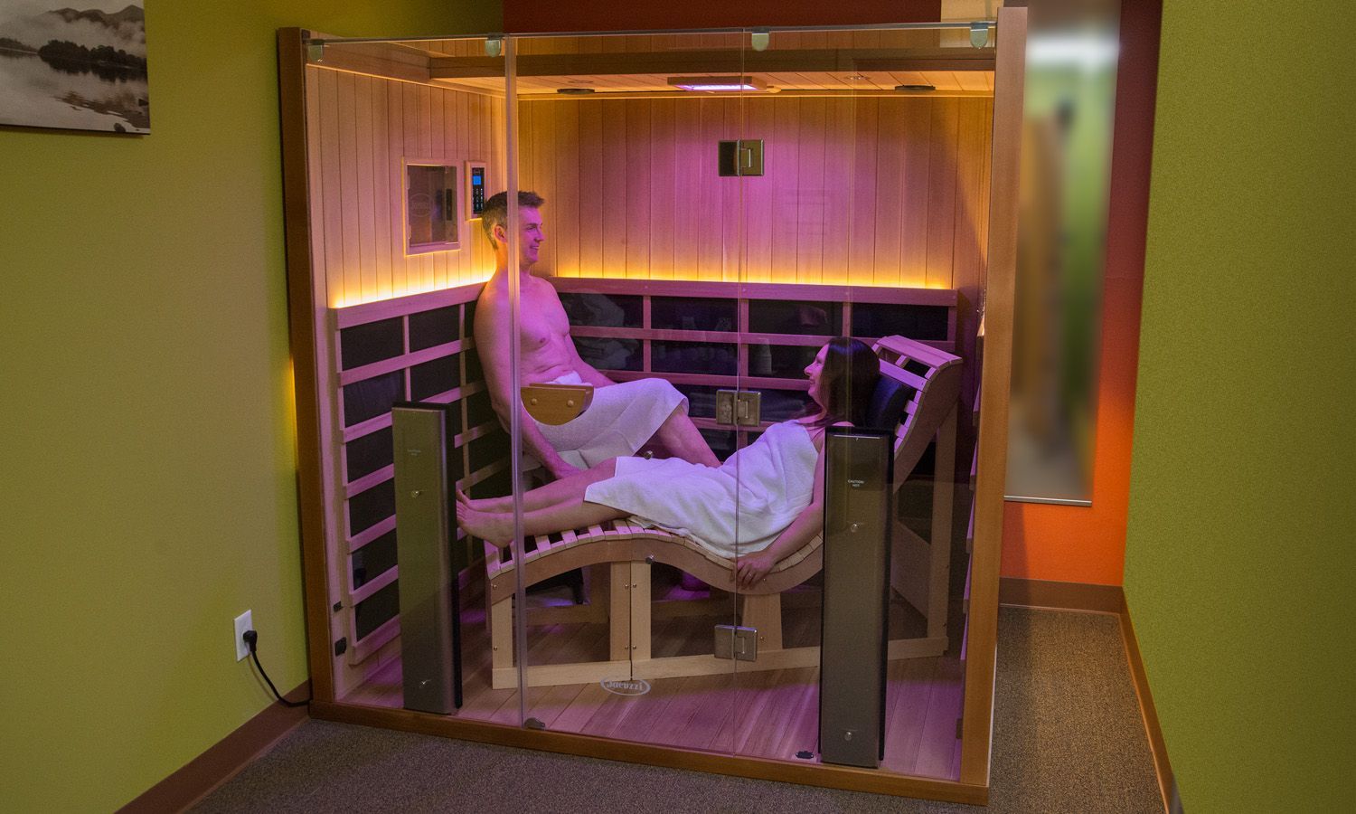 A man is sitting in a chair in an infrared sauna.