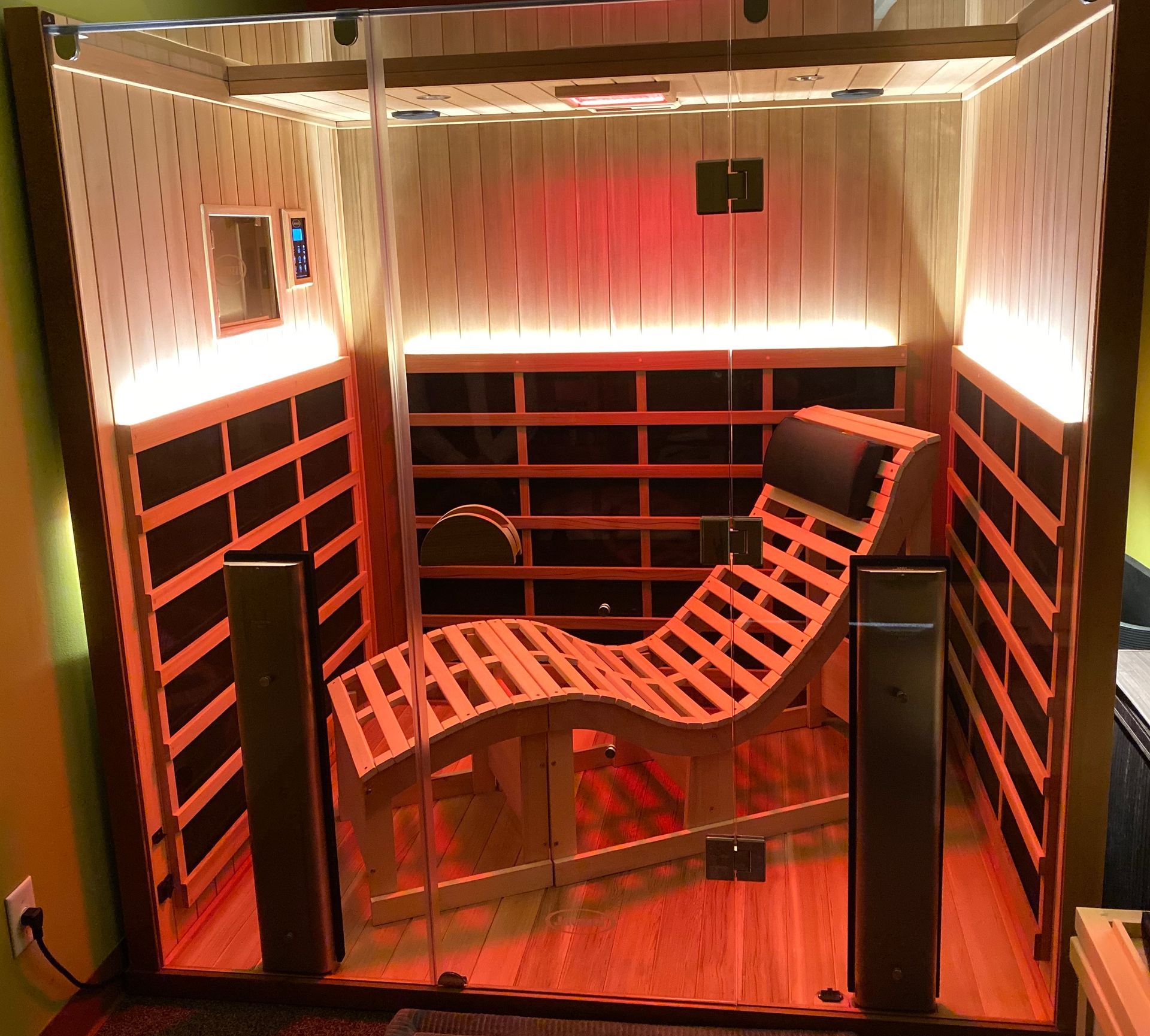 A man is sitting in a chair in an infrared sauna.