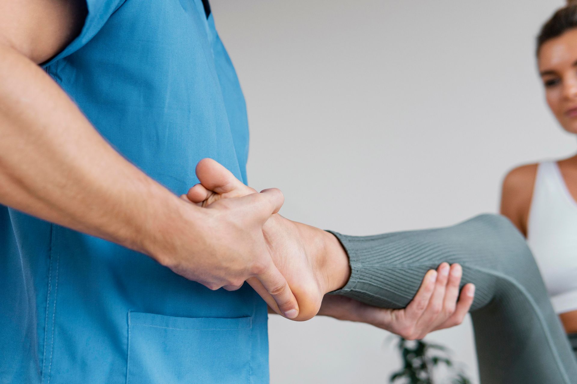 a woman is working with small dumb bells with a health practitioner