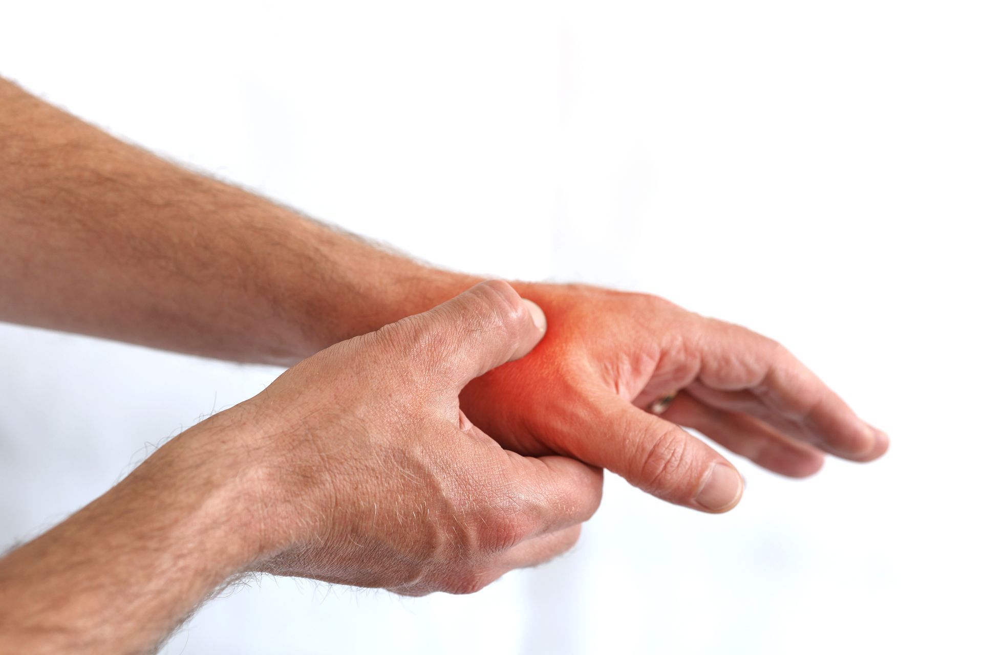 Man holding his wrist with a red spot, indicating pain.