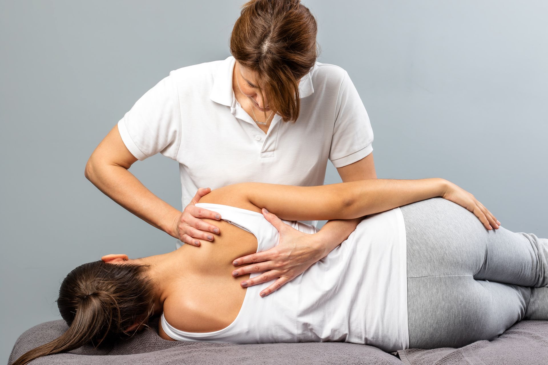 Woman receiving back massage from another person.