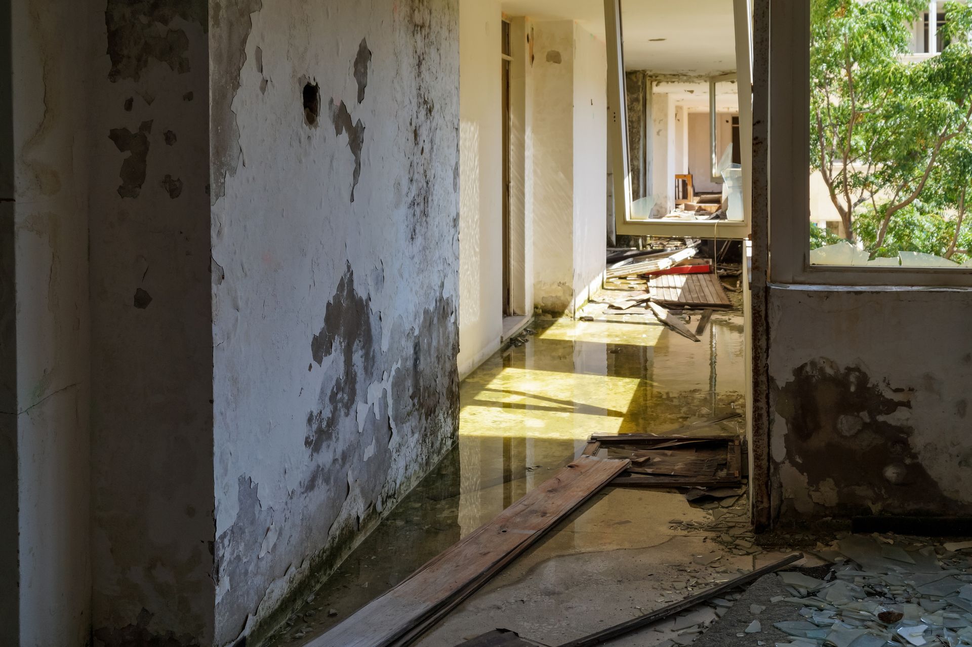 A hallway in an abandoned building with water coming out of the walls A hallway in an abandoned building with water coming out of the walls