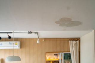 A room with a ceiling that has water coming out of it. A room with a ceiling that has water coming out of it.