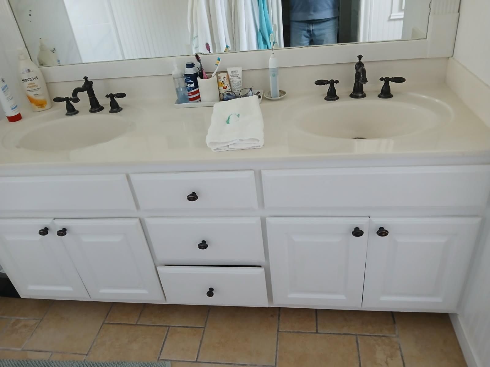 A bathroom with two sinks and a mirror