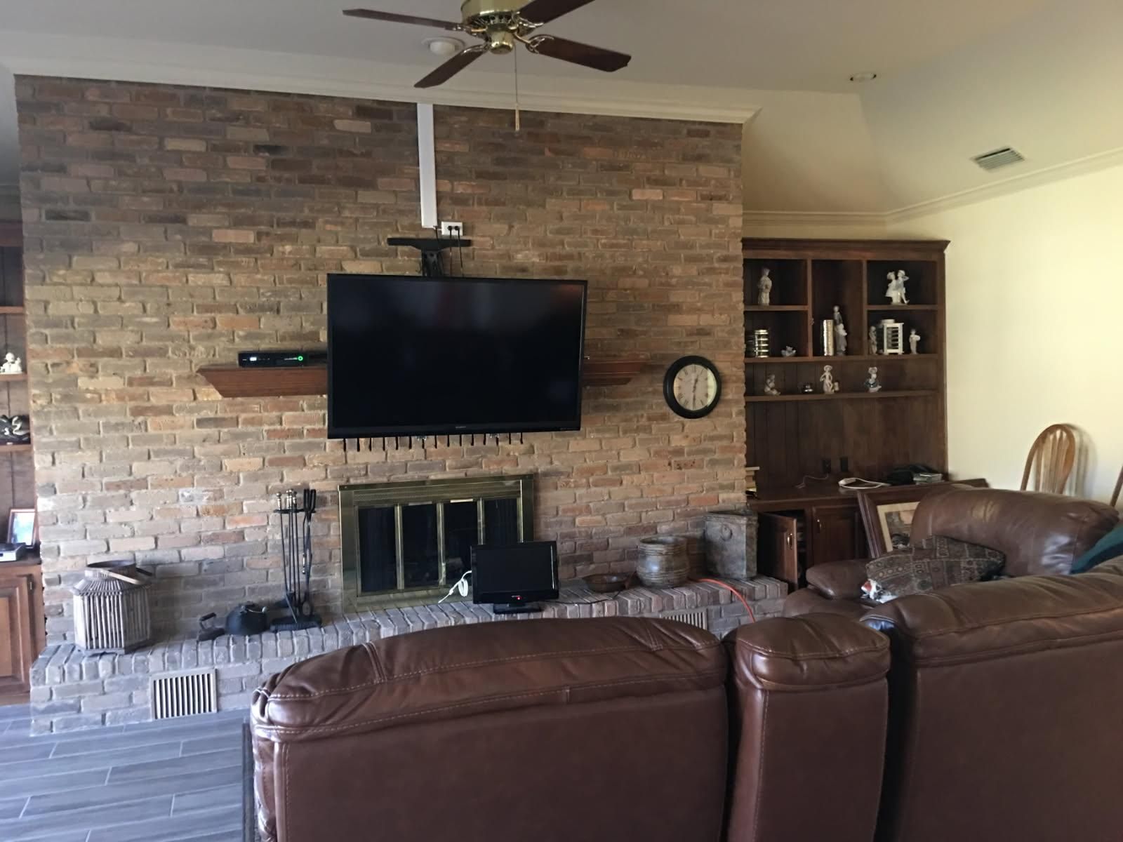 A living room with a fireplace and a flat screen tv