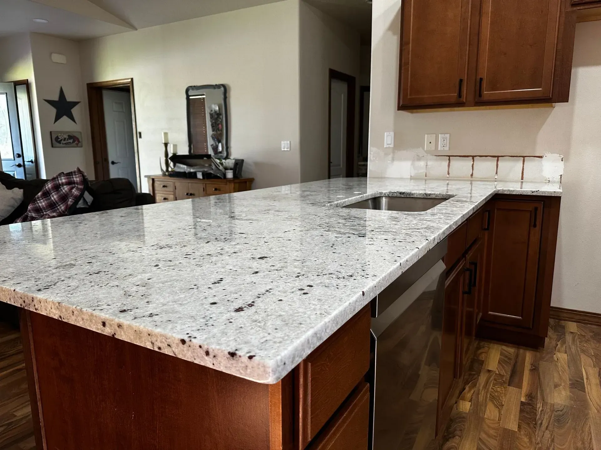 A man is working on a kitchen in a house under construction