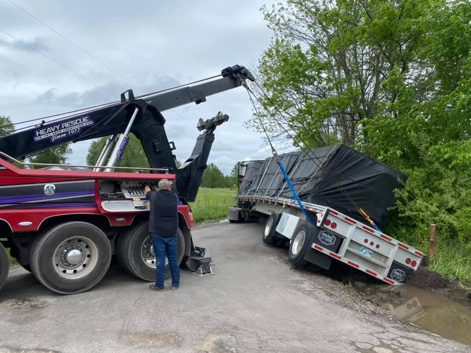 Tow truck attempts to pull a semi-trailer from a ditch. 