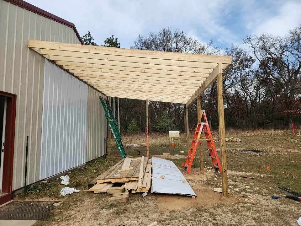 House under construction with scaffolding against white exterior, blue sky.