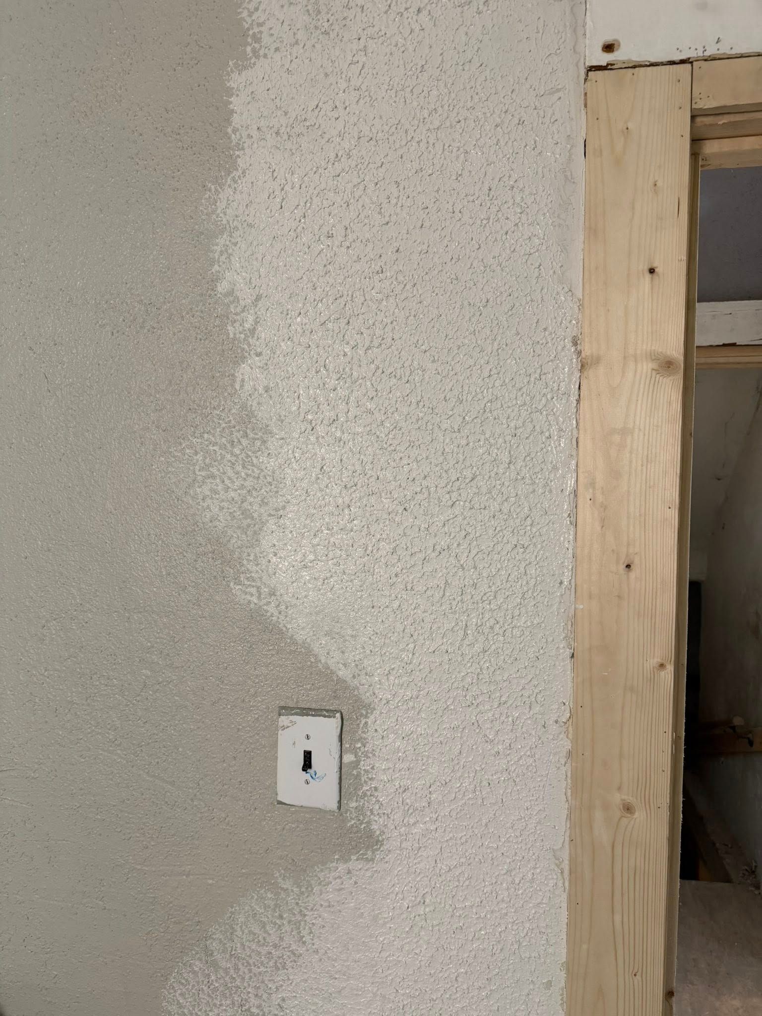 A person holding a baby up in the air indoors near a window, baby smiling.