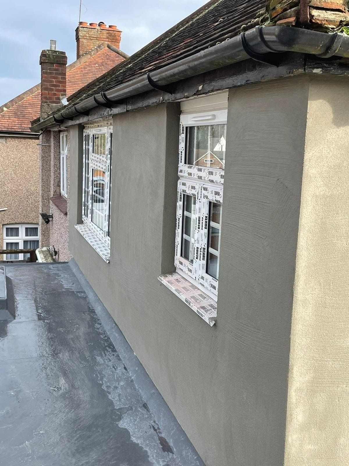 A picture of external render of a bungalow by painters and decorators London