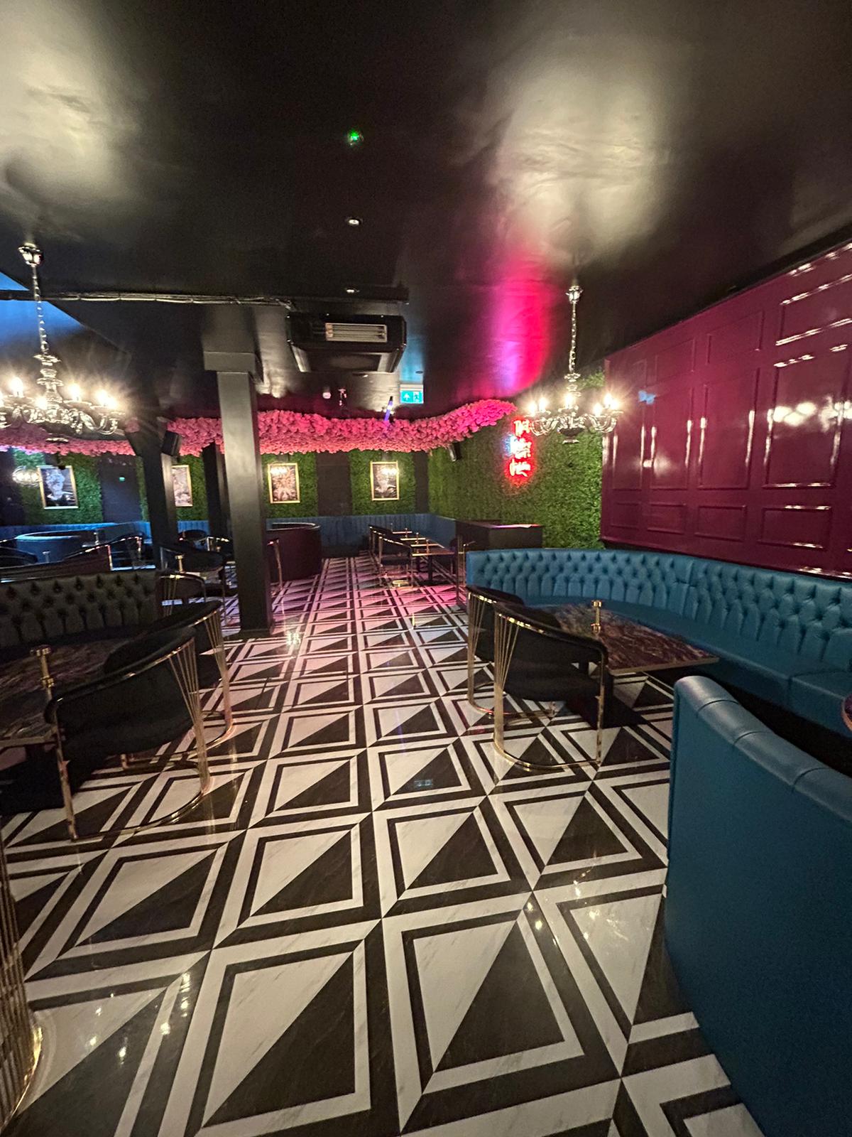 Interior decorating of a shisha lounge in black and pink, with black and white vinyl flooring by painters and decorators London