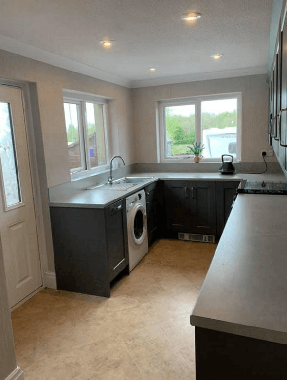 Picture of a new kitchen with grey cabinets and white walls painted by painters and decorators in London