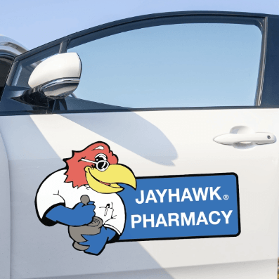 A white car with a sticker on the door that says jayhawk pharmacy
