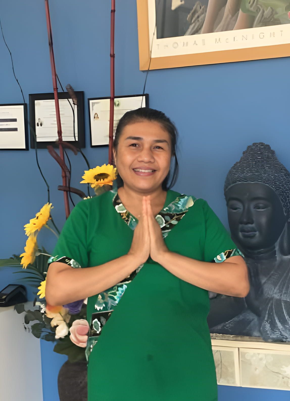 A Cheerful Woman in a Green Shirt and Black Pants Beams With a Smile — Nancy's Traditional Thai Massage In Buderim, QLD