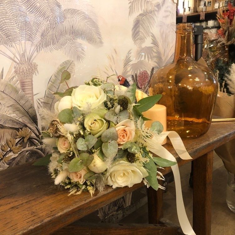 Un bouquet de fleurs est posé sur une table en bois.