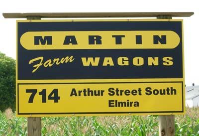 Sign for Martin Farm Wagons, yellow and black, with address 714 Arthur Street South, Elmira.