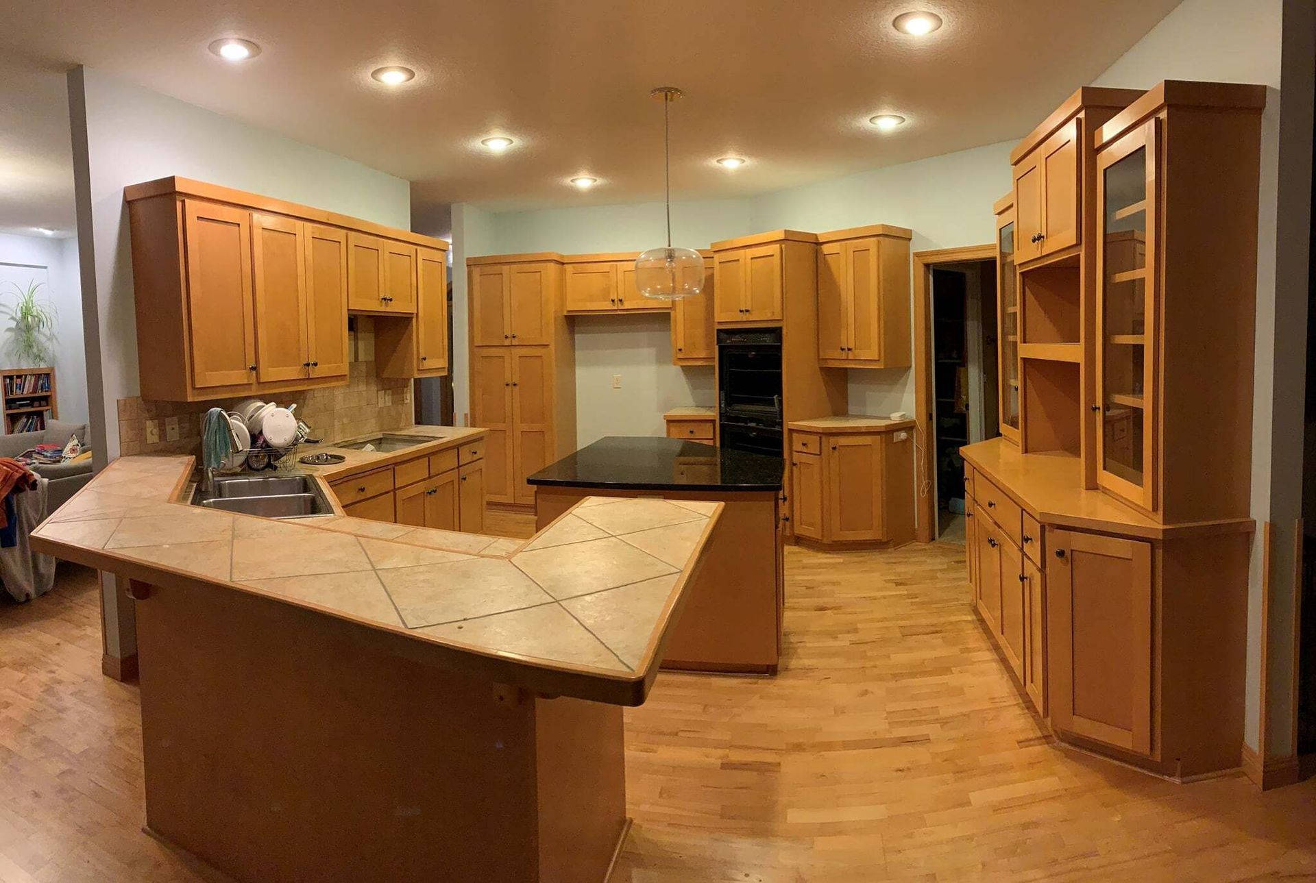 Kitchen with Wooden Cabinets and a Black Counter Top — St Cloud, MN — Fine Line Paint LLC