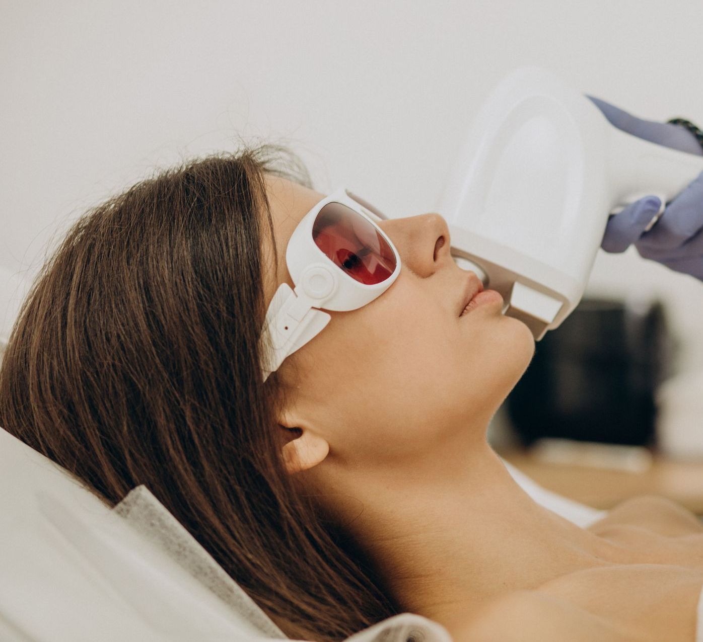 a woman is getting a laser treatment on her face