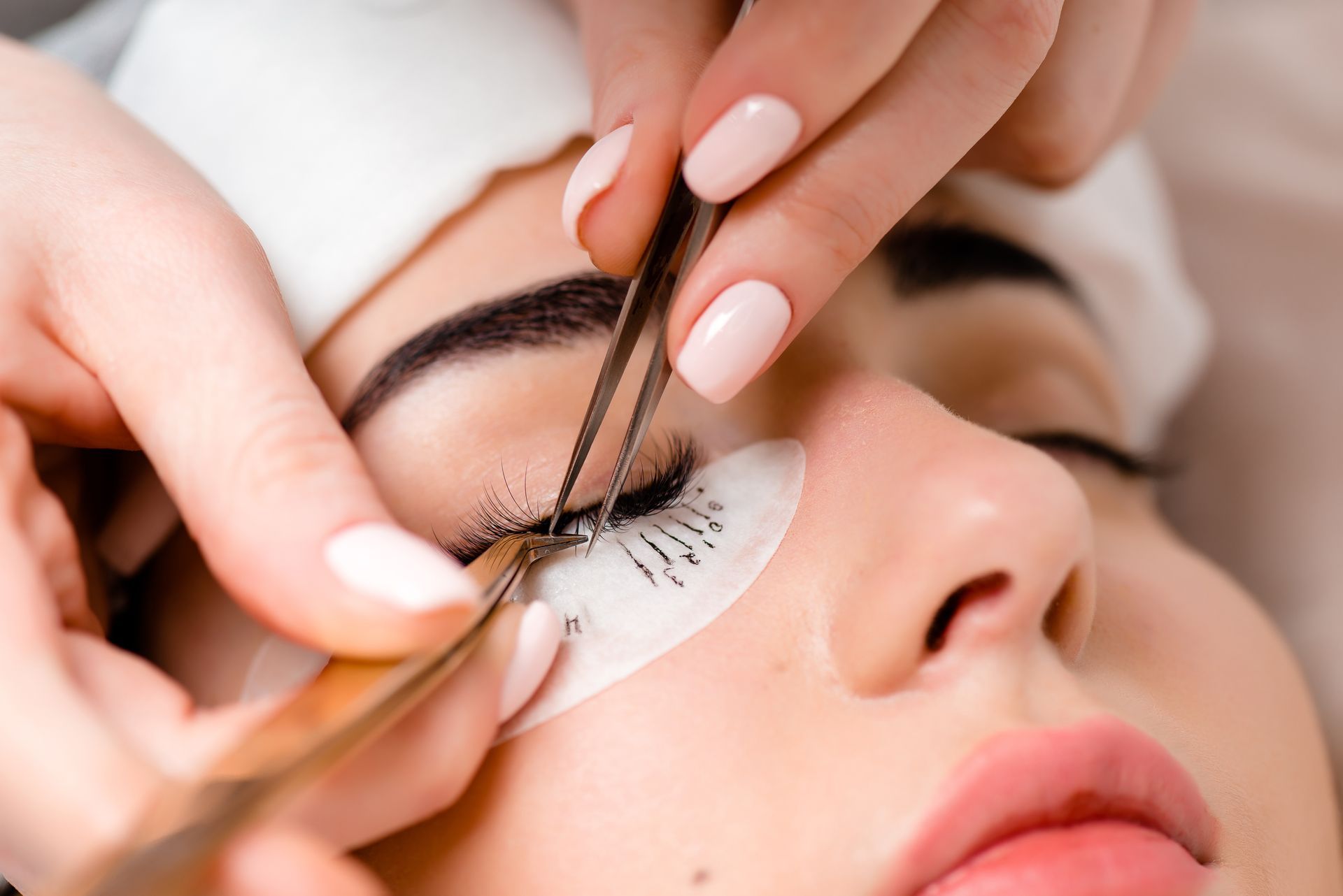 a close up of a woman getting eyelash extensions