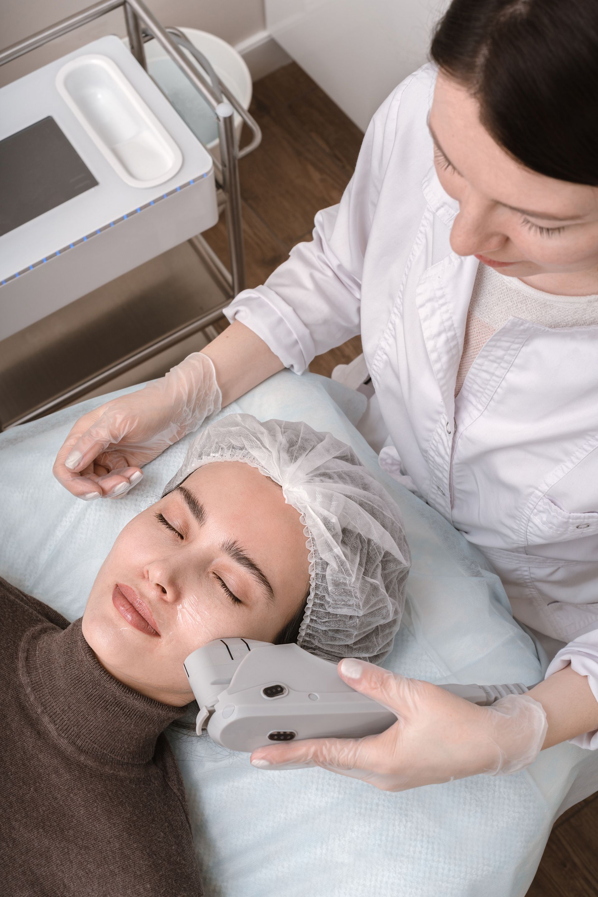 a woman is getting a facial treatment from a doctor
