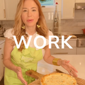 Woman in kitchen wearing green apron, pointing at food.