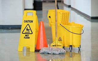 Janitorial Services — Wet Floor Sign With Mop in Fort Collins, CO